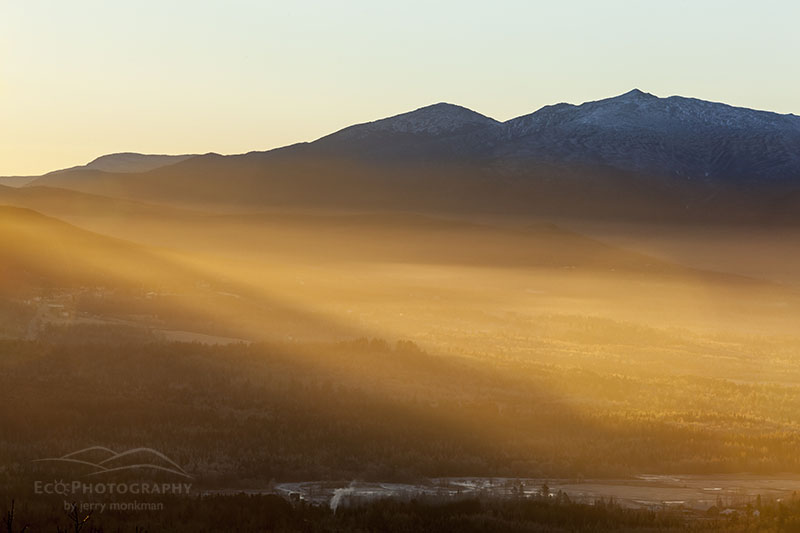 Sunshine breaks through the White Mountains as seen from Weeks State Park in Lancaster, New Hampshire.